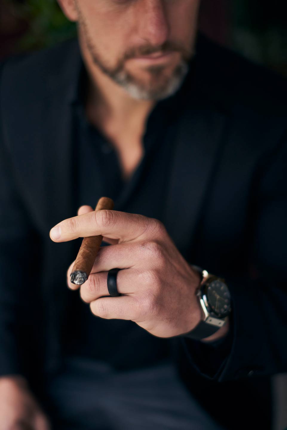 Lifestyle photography of elegant man holding cigar